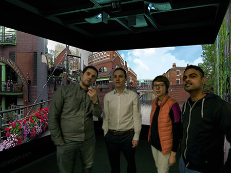 A group stand inside a Cube system to look at a canal scene at Brindley Place in Birmingham 
