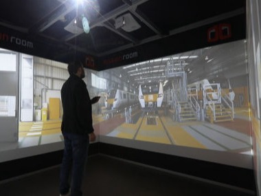 A man watches a 360º video of a train depot in a Cube system