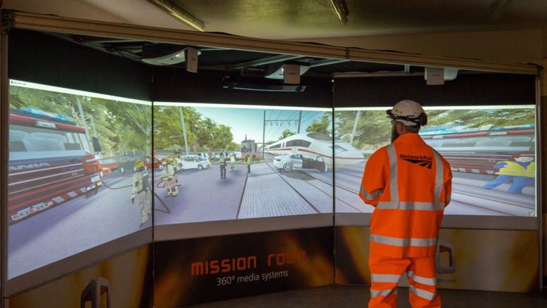 A rail worker uses XVR on a Cine system to navigate a virtual train crash